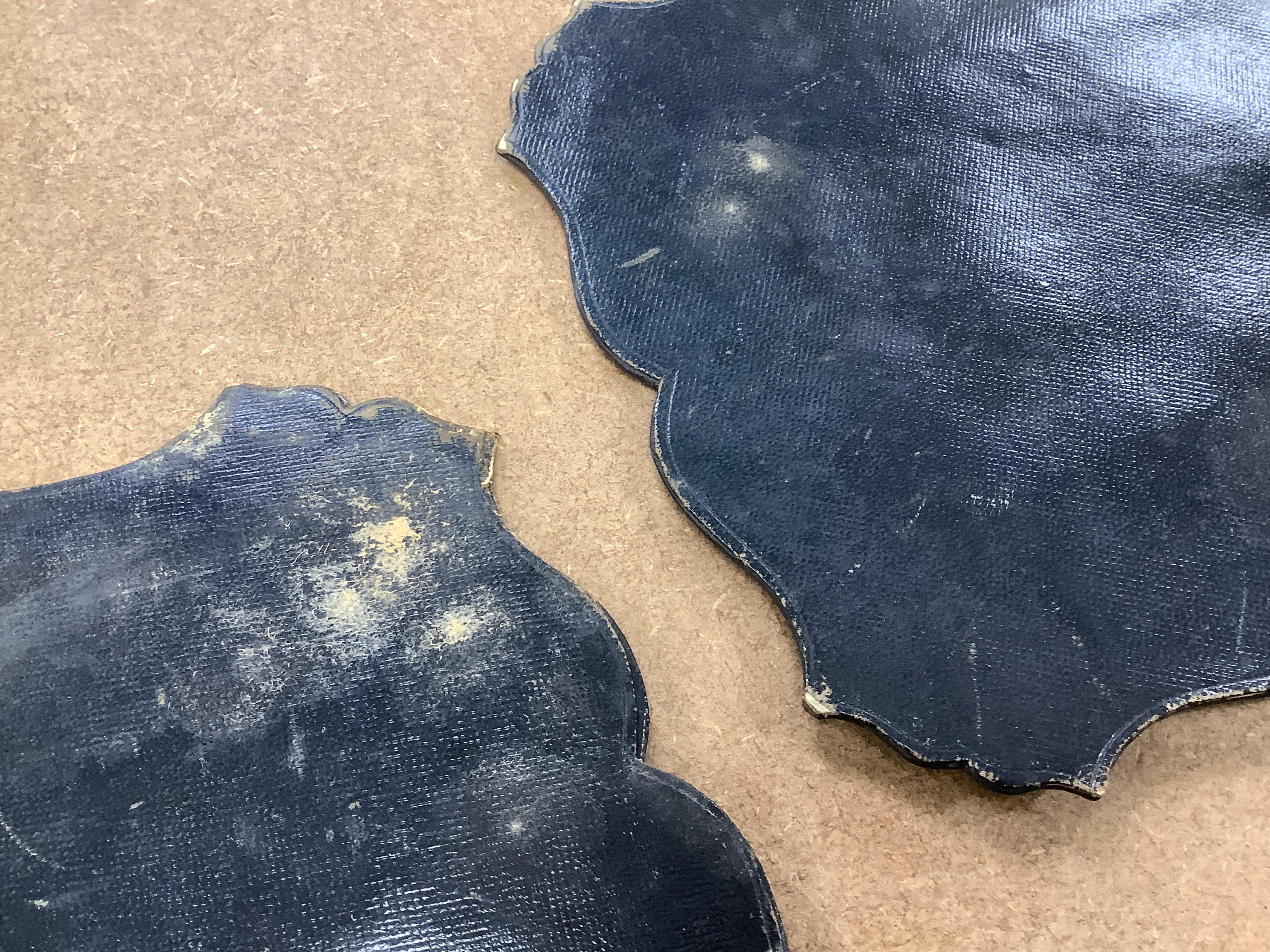 A pair of early Victorian papier maché hand screens, each with embroidered with cross stitched flowers, 41cm in length